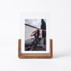 U shaped acrylic and wood photo frame on a plain white background