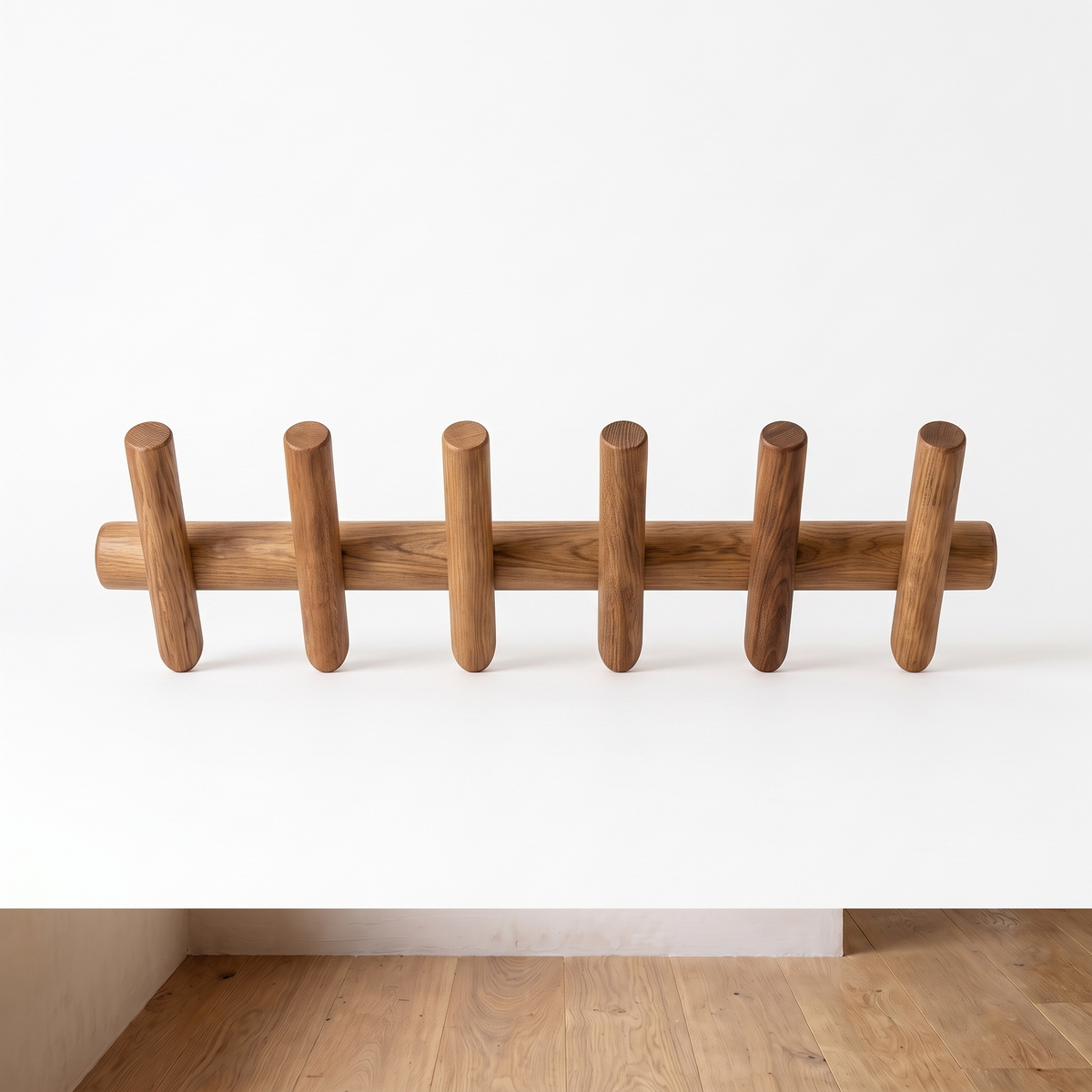 Maeve solid oak wall rack on a plain white background