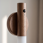 Close up of the walnut grain and diffuser on the Noctis wall light