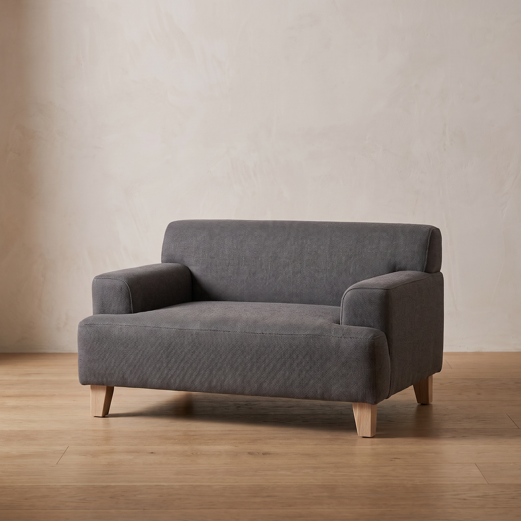 Atelieree Linnea elevated pet sofa on an oak floor against a pale plastered wall
