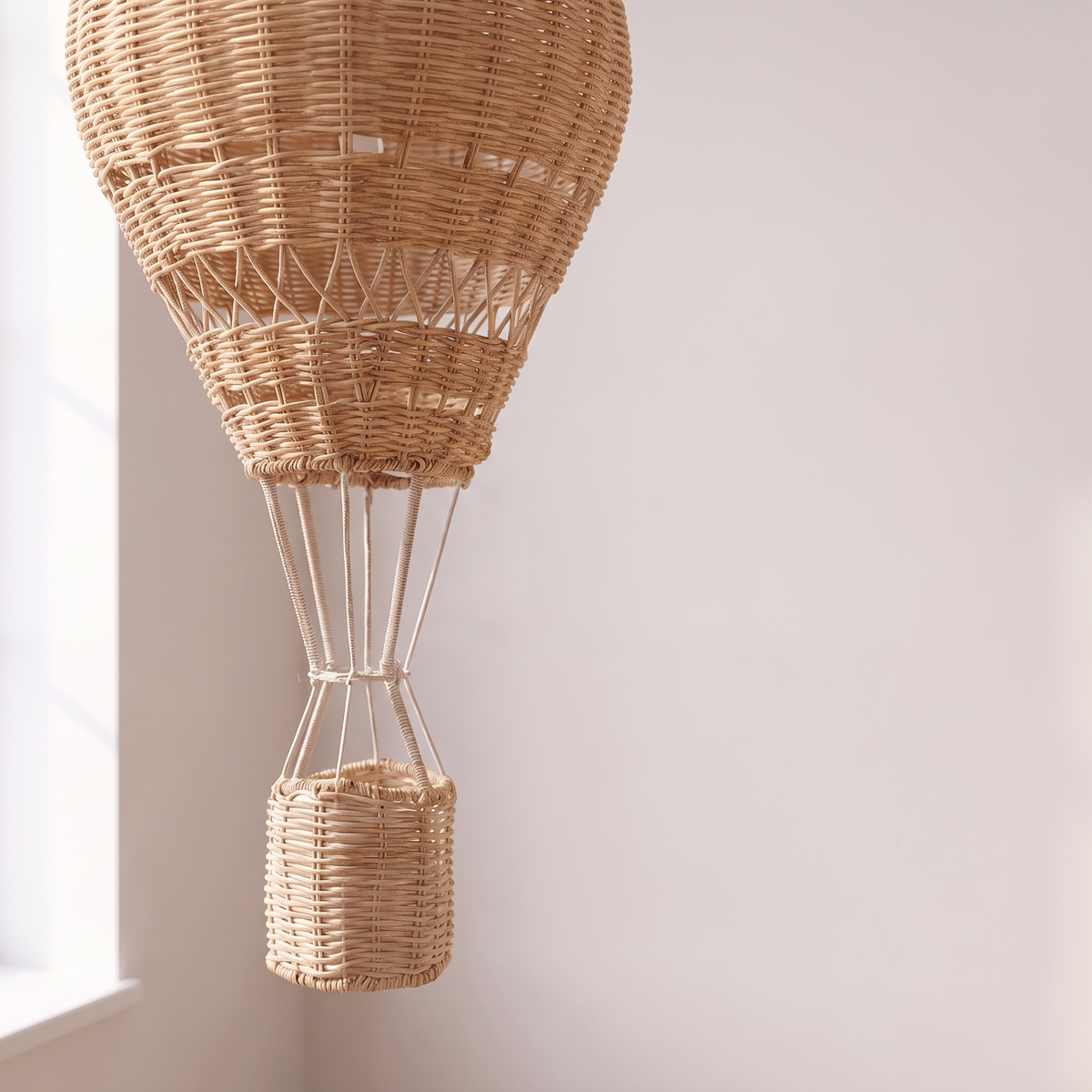 Close detail of the handwoven rattan weave and basket on the Atelieree Aero pendant