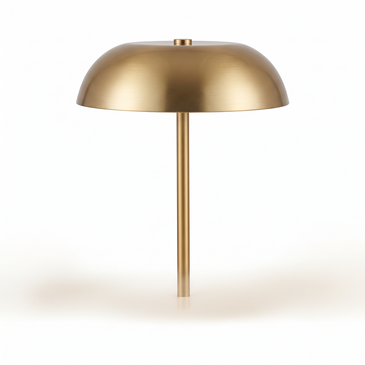 Gold iron cordless mushroom table lamp switched off on a white background