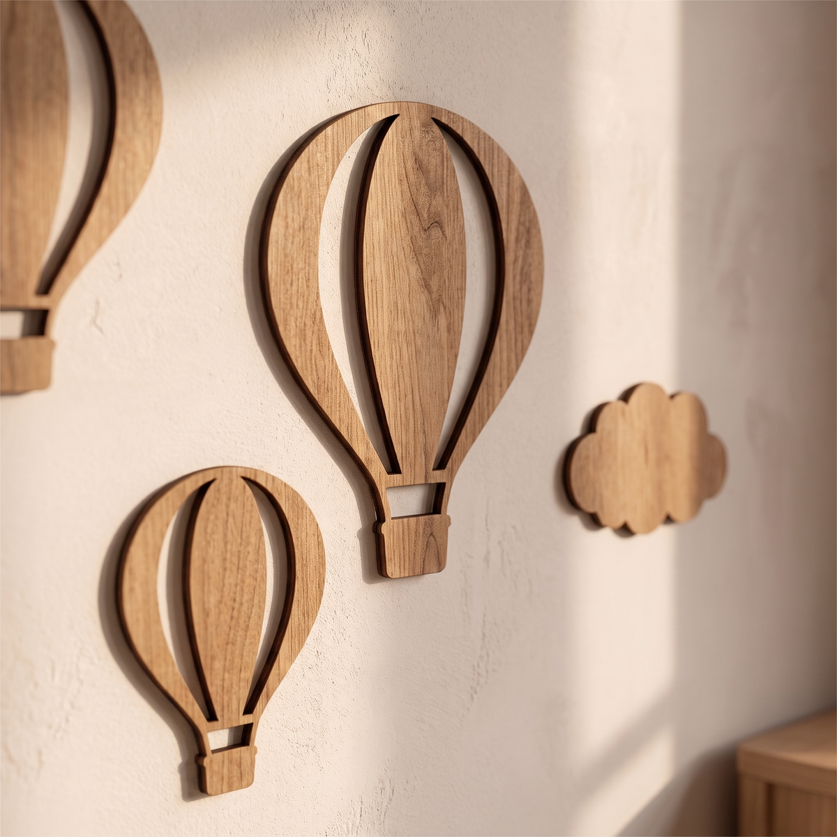 Close detail of two wooden balloons and a cloud showing the wood grain and cut edges