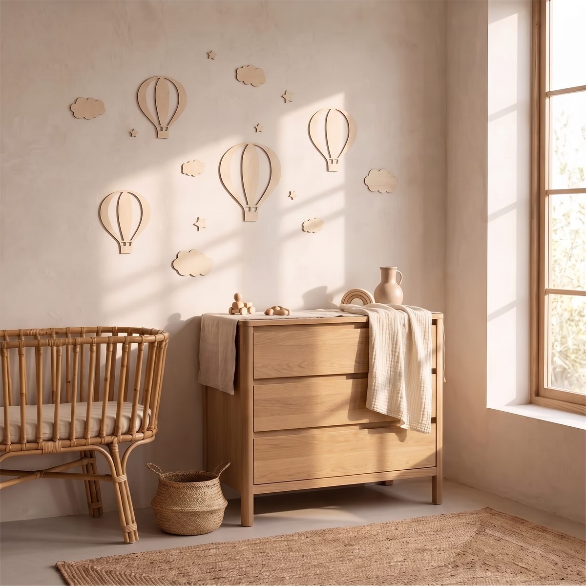 The balloon wall set in a lived in nursery with a muslin blanket and woven basket