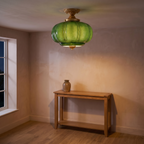 The same hallway in the evening with the green glass ceiling light switched on and glowing
