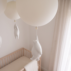 Close detail of a moulded resin bear hanging beneath an opaque acrylic balloon shade