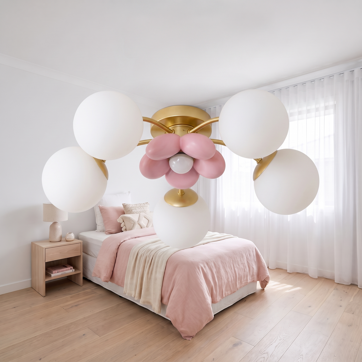 Close view of the gold arms, opal white glass globes and pink glass petal centre