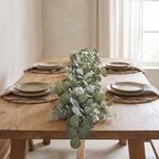 Eucalyptus garland running down the centre of an oak dining table
